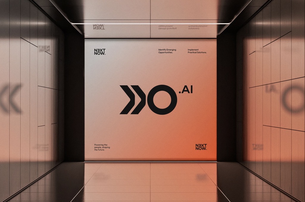 Next Now AI brand environment wall with logo and tagline
